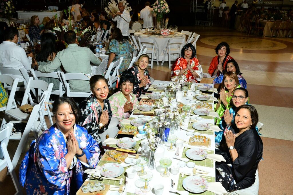 Personas en evento elegante con comida y decoración.