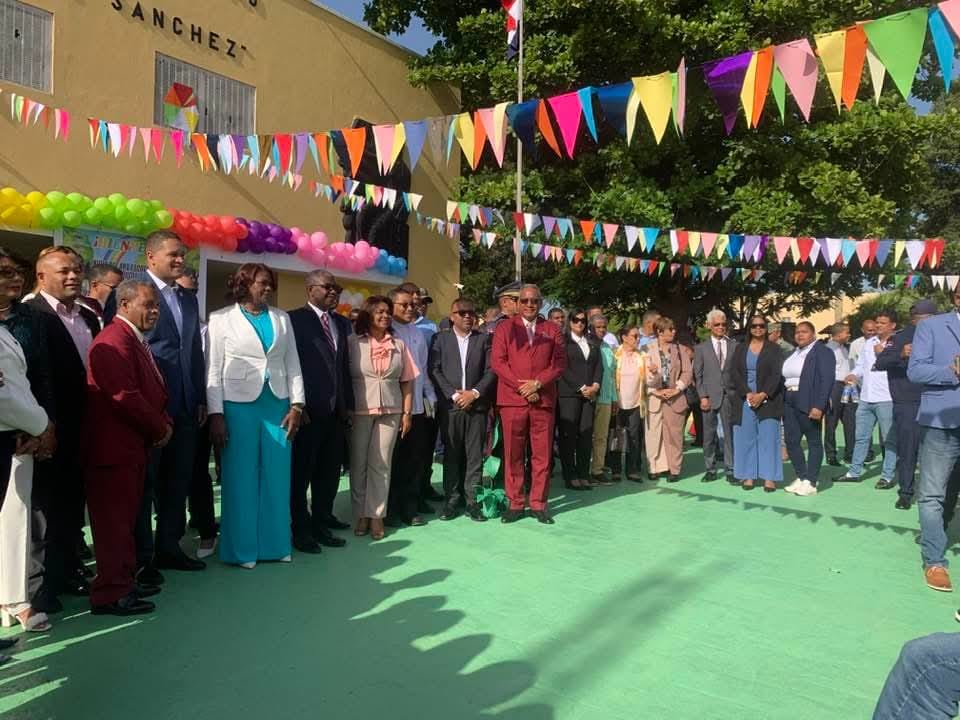 Celebración grupal con banderines coloridos al aire libre.