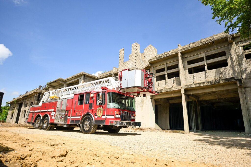 Camión de bomberos frente a edificio en construcción.