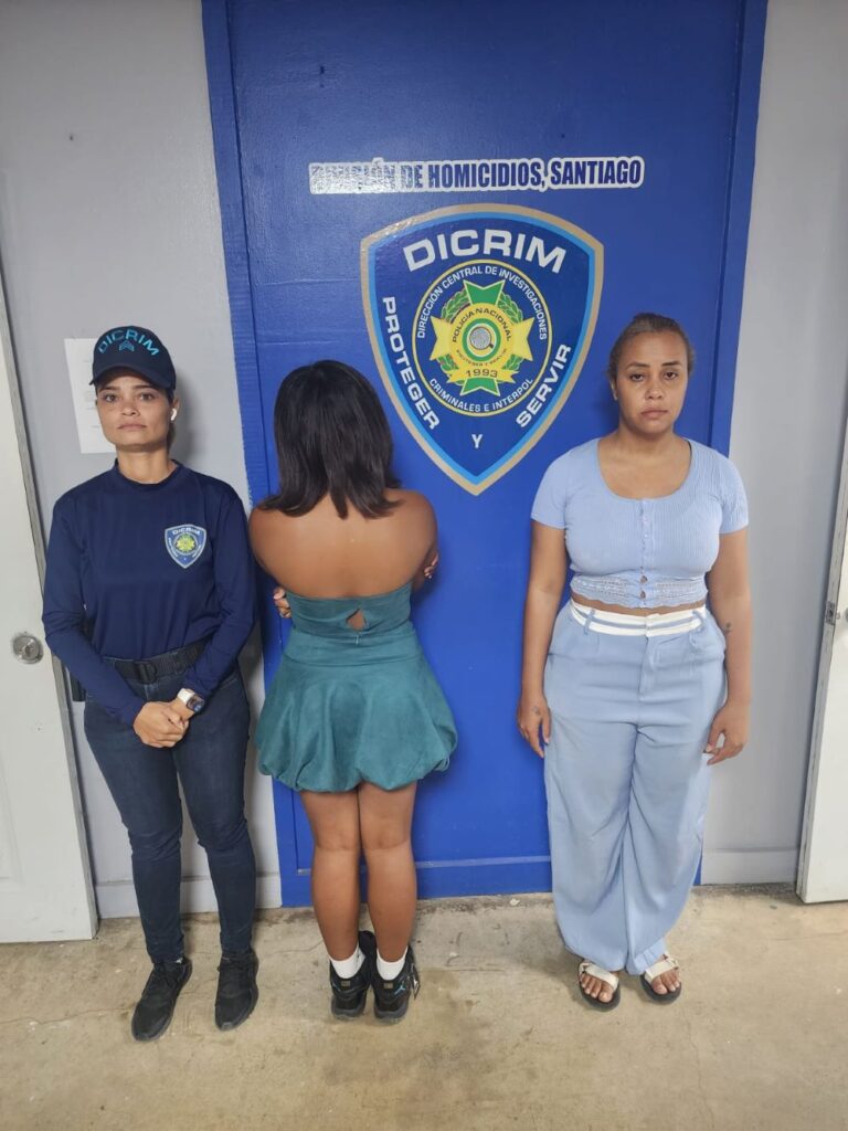 Tres personas frente a oficina de homicidios DICRIM.
