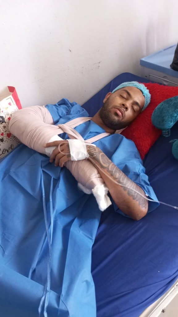 Hombre hospitalizado descansando con brazo vendado.